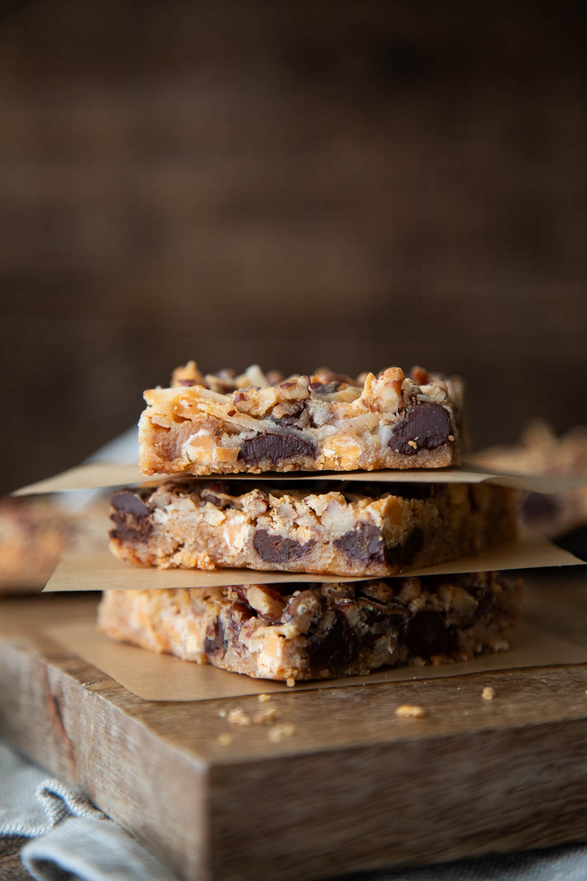 old fashioned 7 layer bars on parchment paper squares
