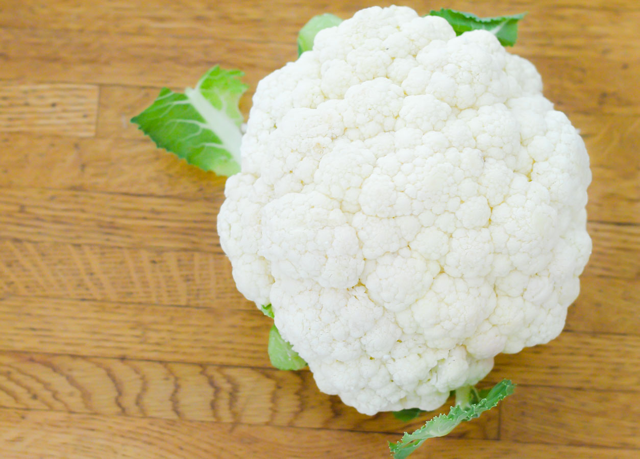 Head of White Cauliflower on Wood Table