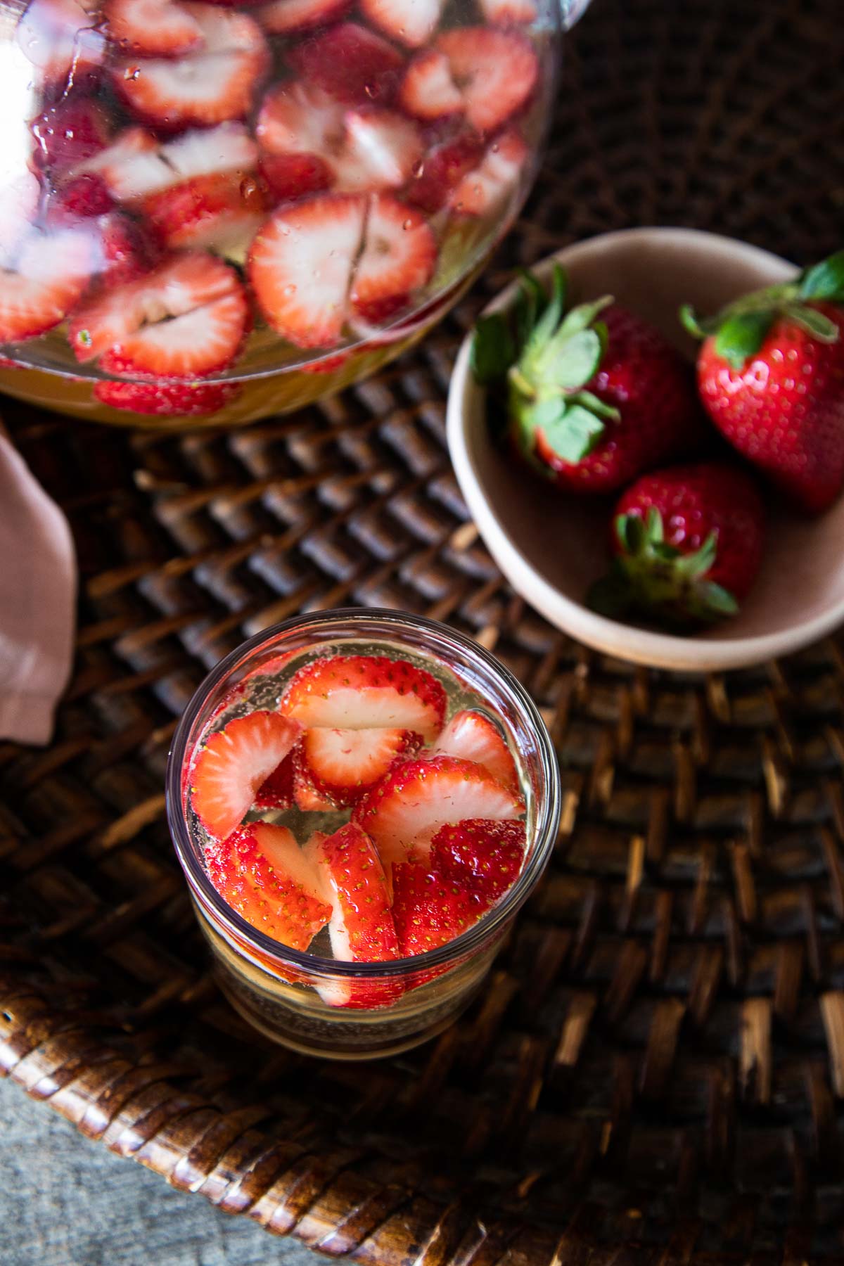 Strawberry sangria in glass - top down photo with cut up strawberries