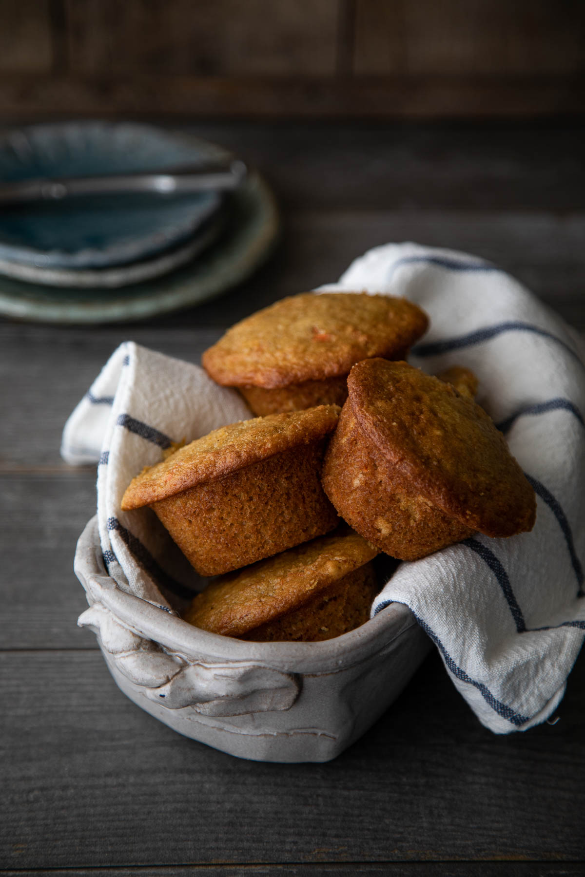 Healthy orange muffins in towel lined basket