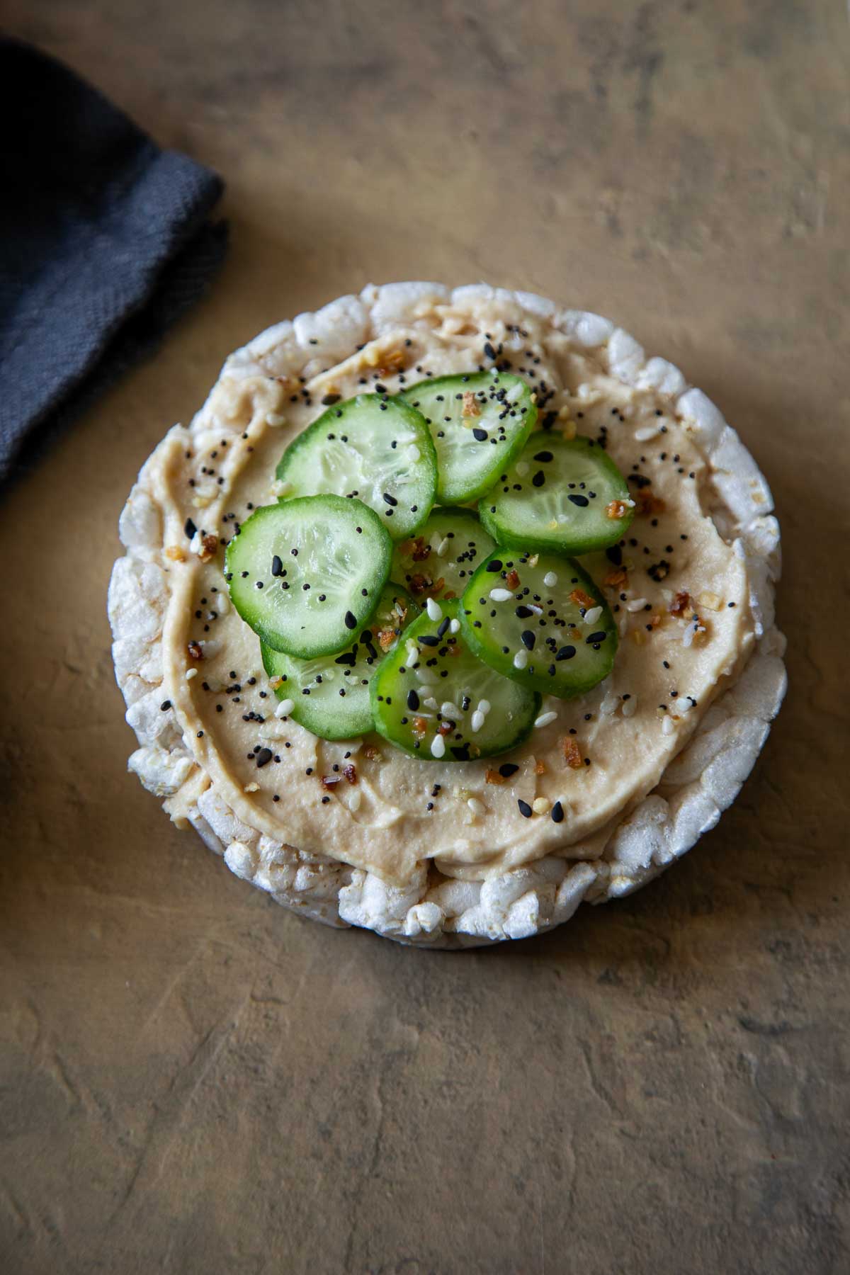 CUcumber slices, hummus, and everything seasoning on Rice Cake - Healthy Rice Cake Snacks + Toppings