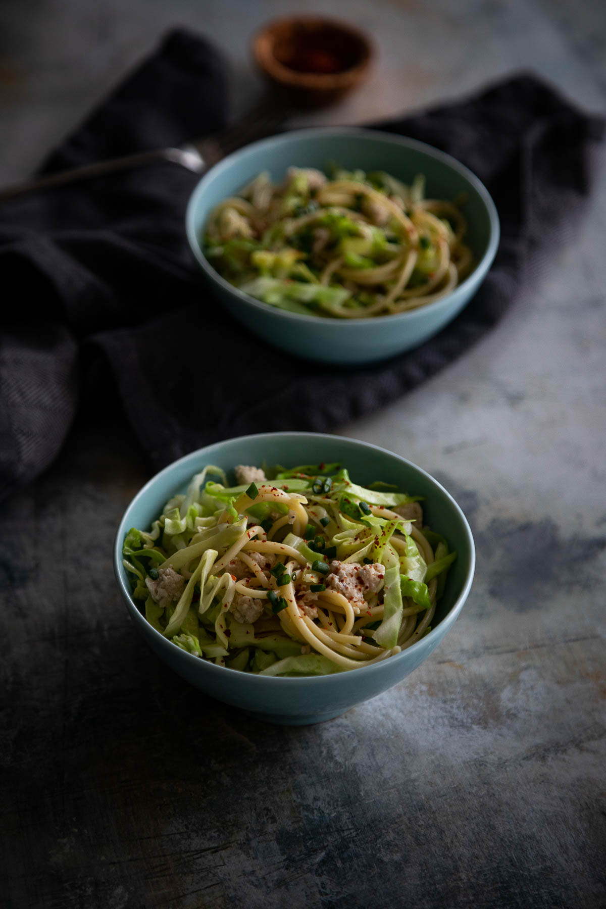 ground turkey and cabbage pasta in small bowl on shadowy table