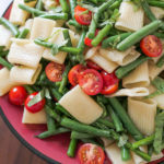One Pot Summer Vegetable Pasta. This bright and delicious vegetarian dinner recipe combines the summer flavors of asparagus, green beans, and fresh tomatoes with a rigatoni recipe. #dinnerrecipes #vegetarian #plantbased #pasta #foodblog