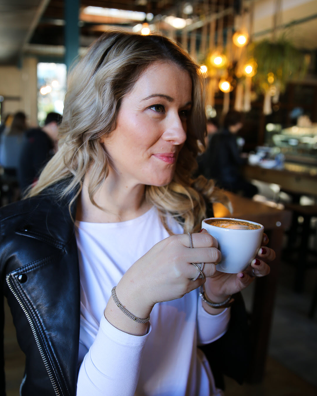 Luci Holding Cappuccino with LAGOS Caviar Bracelet + Rings -