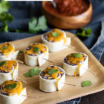 Mexican Pinwheels. These Mexican Roll Ups with Black Beans and Cheese are a super easy, vegetarian appetizer. It's also the perfect, Cold Mexican Appetizer - great for warm days when no bake recipes are the only option! #mexican #appetizers #coldappetizers #cincodemayo #appetizers #appetizer #lmrecipes