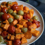 Try this Roasted Sweet Potato Salad this fall. Delicious sweet potatoes combine with tomatoes for a perfectly sweet and acidic sald that can be enjoyed warm or cold. #lmrecipes #vegetarian