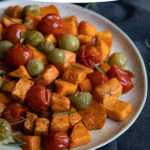 Try this Roasted Sweet Potato Salad this fall. Delicious sweet potatoes combine with tomatoes for a perfectly sweet and acidic sald that can be enjoyed warm or cold. #lmrecipes #vegetarian