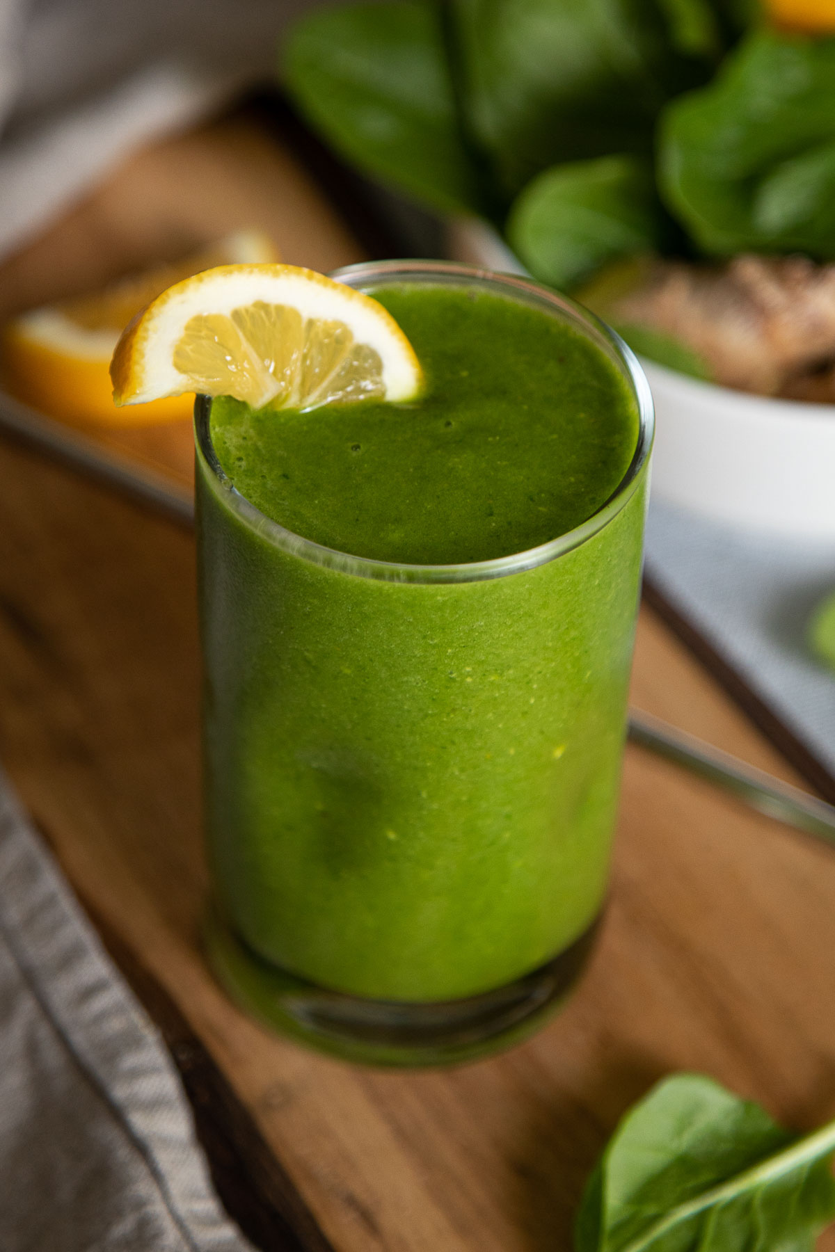 Close up Photo of Ginger Spinach Smoothie with half Lemon slice