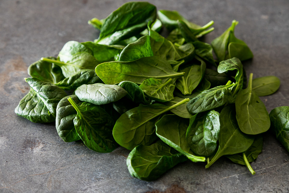 fresh spinach on gray table