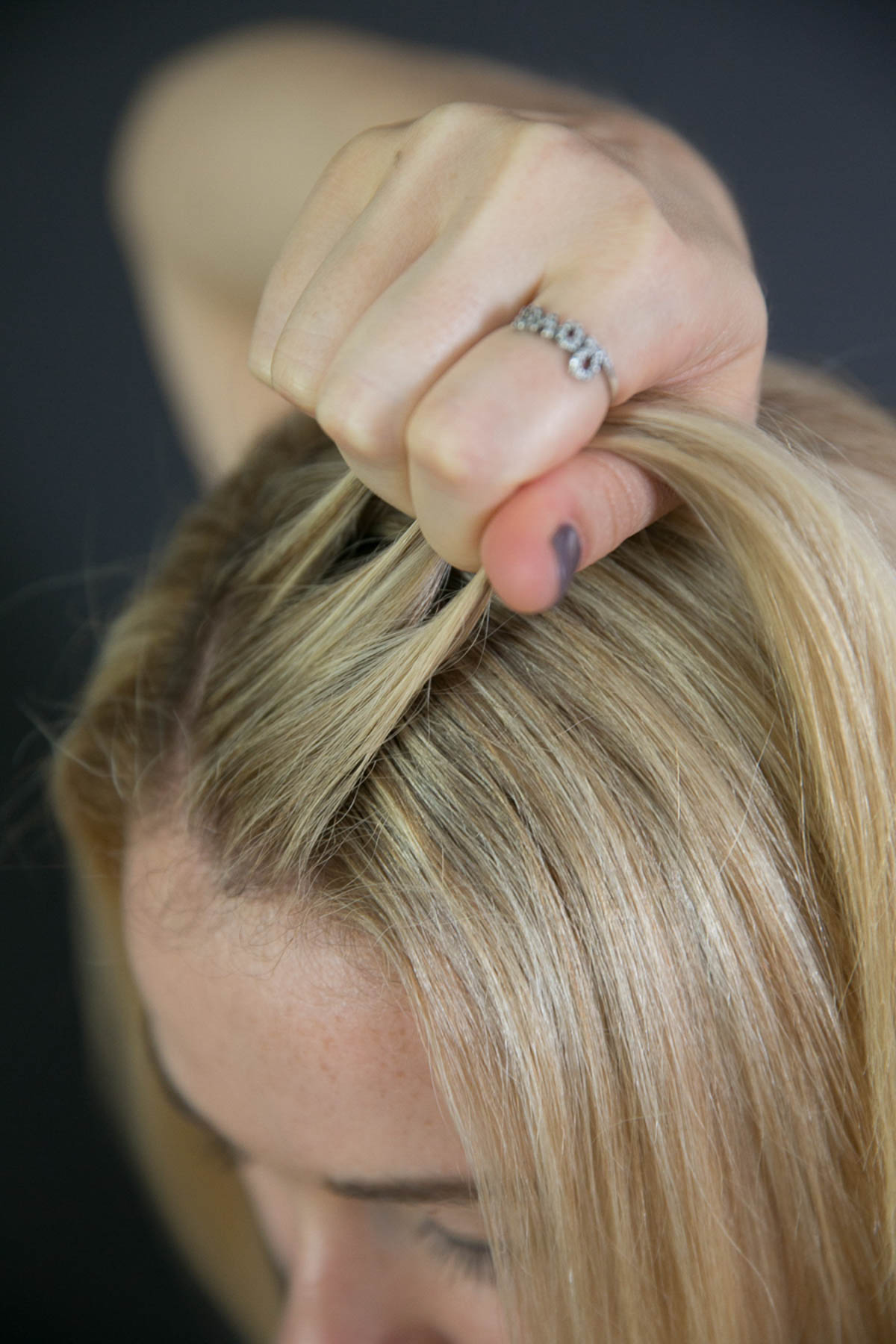 Pulling three parts of hair to be braided - EASY SIDE BRAID TUTORIAL