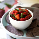 Cilantro Strawberry Salsa in White Bowl with Blue Corn Tortilla Chip Rounds