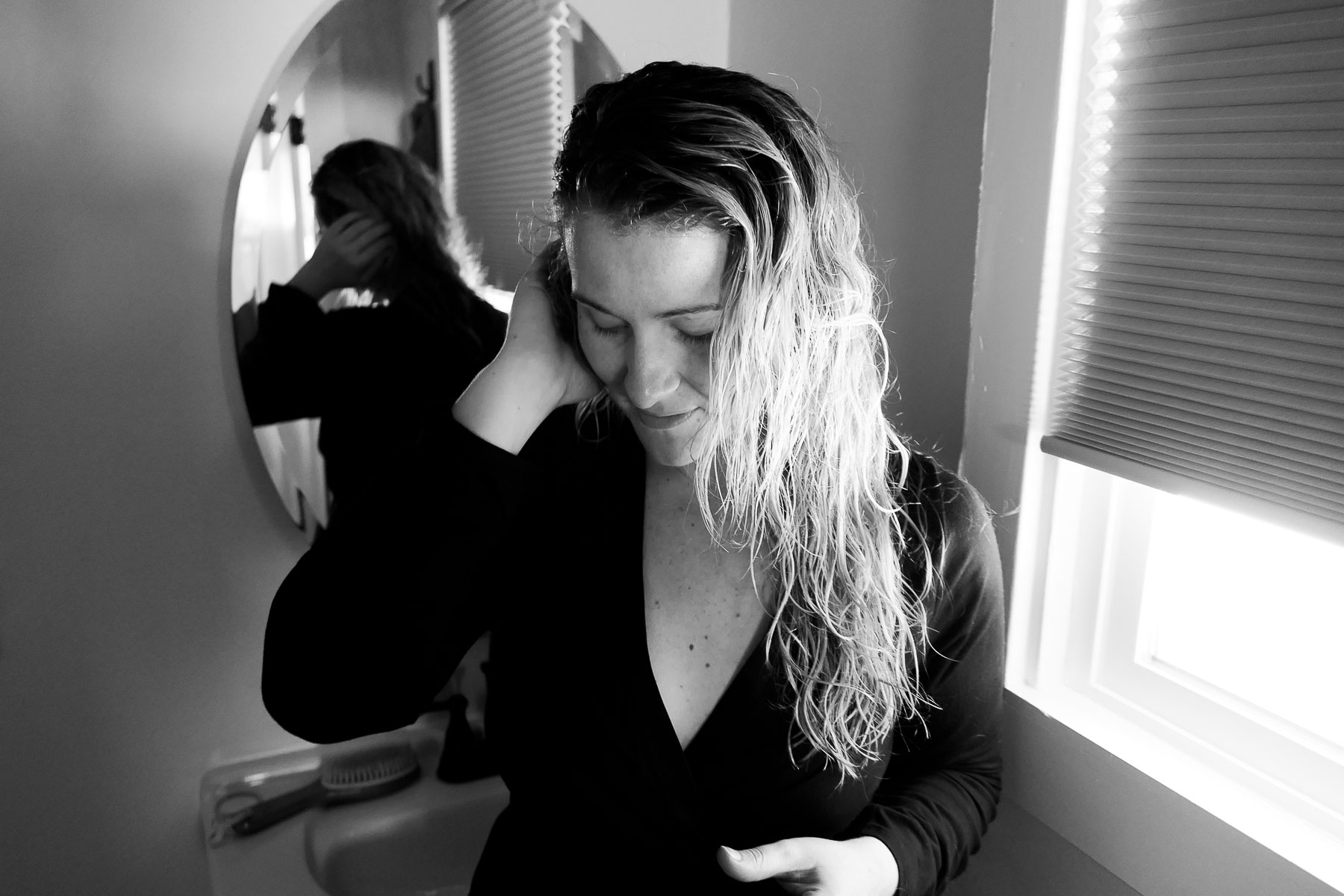 Black and White Image of Girl Tucking Hair Behind Ear - Do Shampoo Bar Really Work?