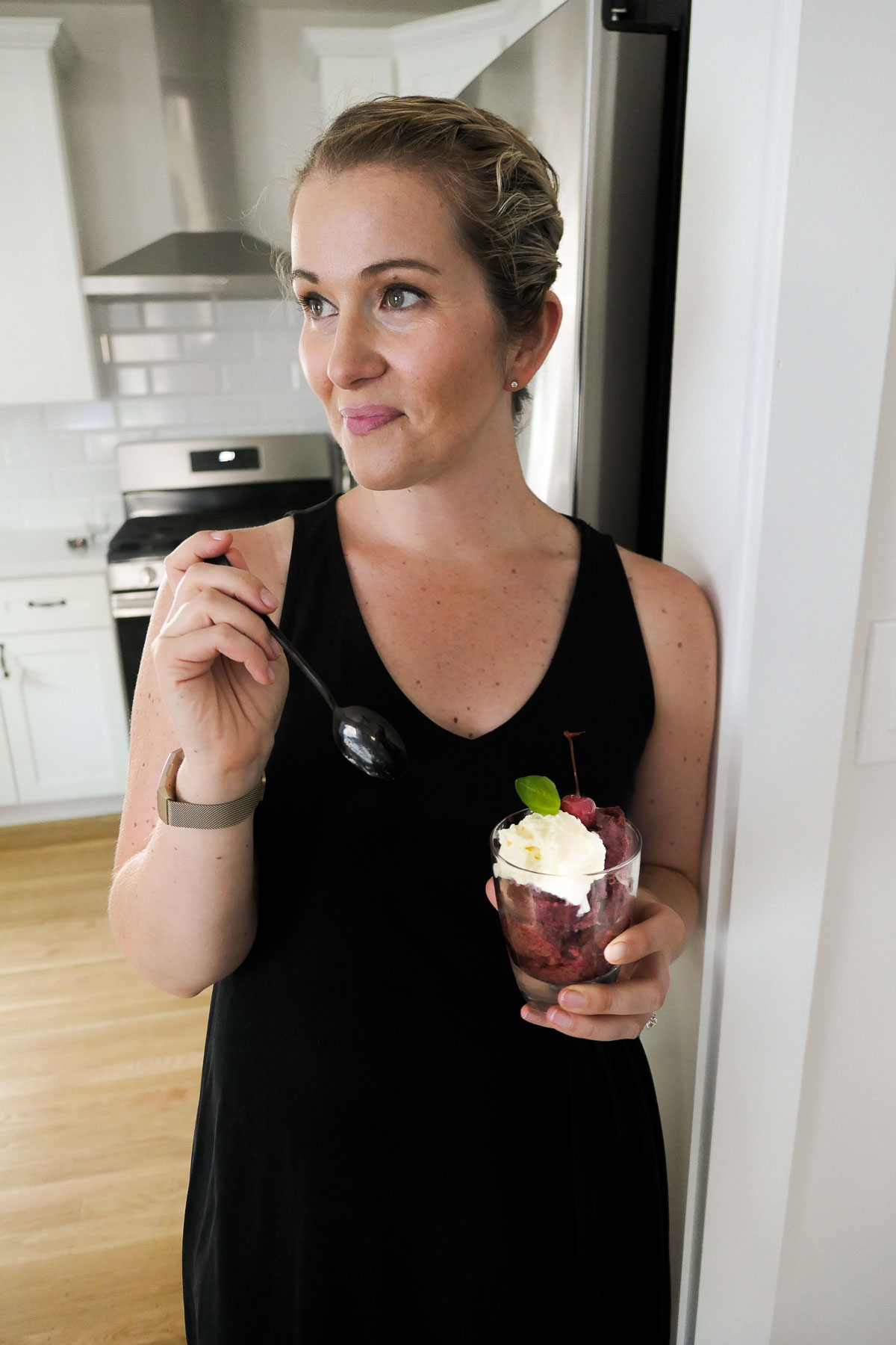 Woman enjoying dessert in kitchen