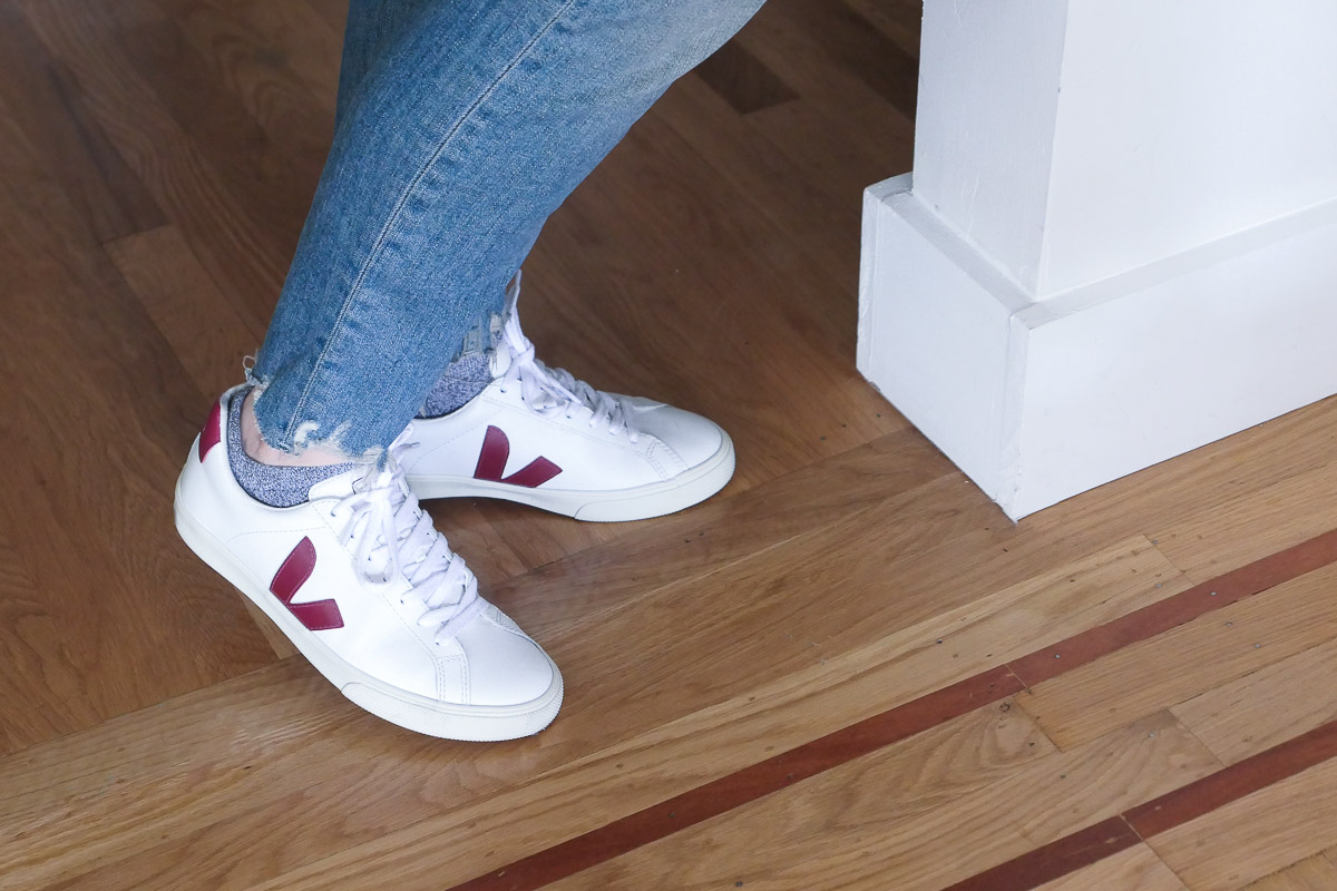 Veja sustainable shoes with distressed blue jeans