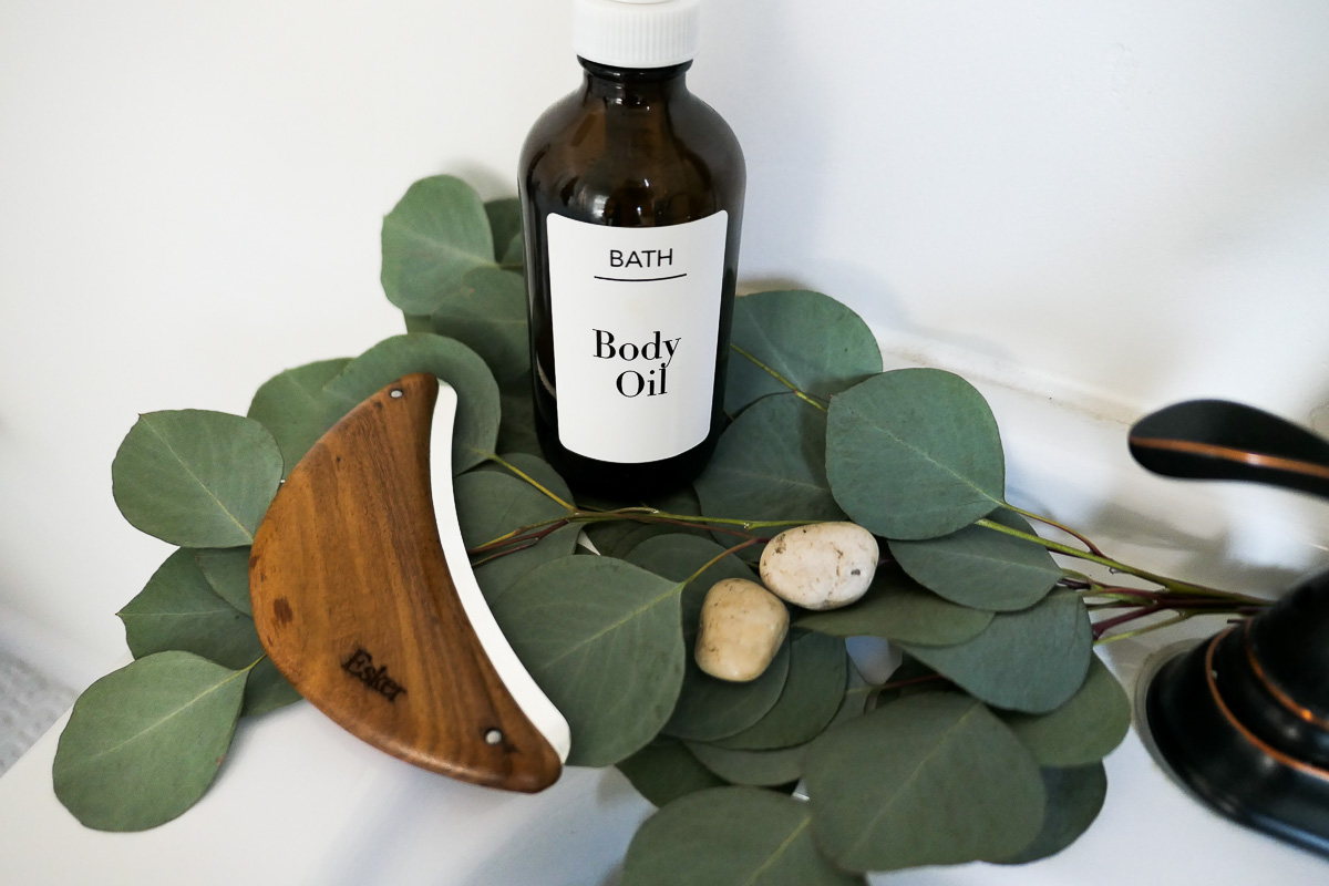 Beauty Body Tools - Body Plane on Green leaves w. Body Oil Bottle