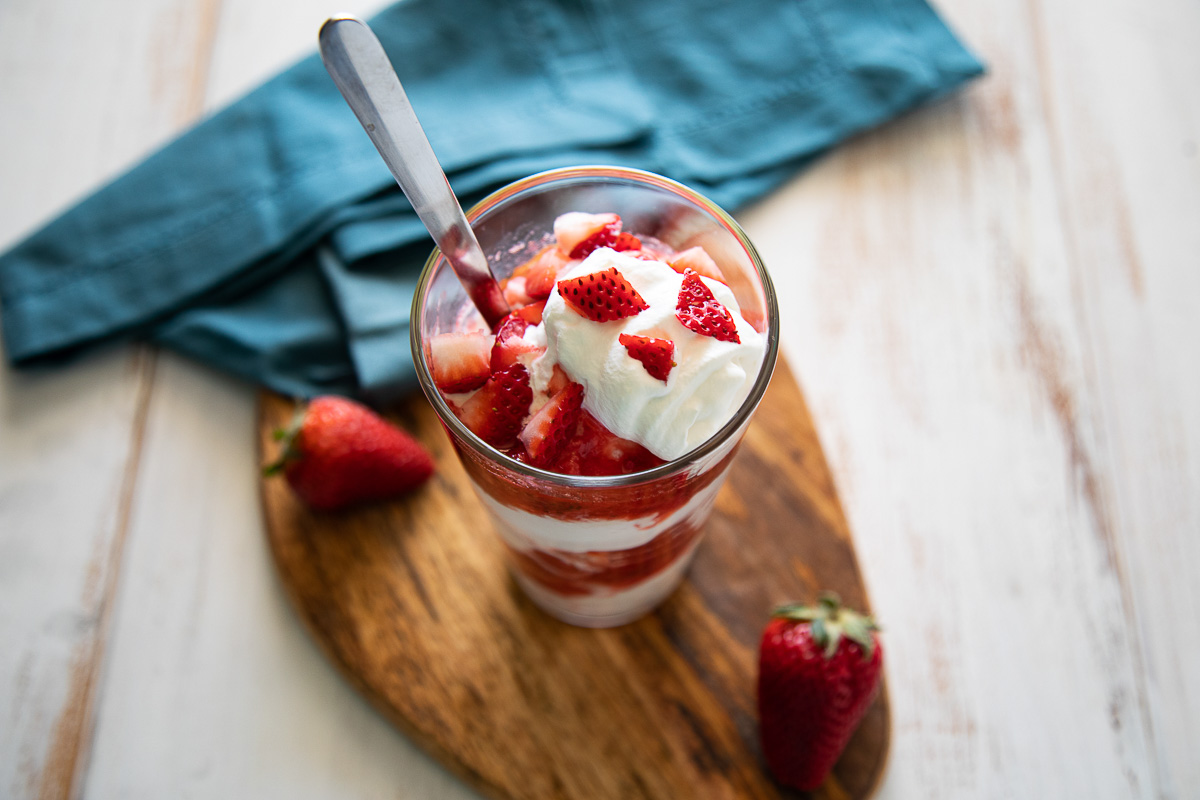 Strawberry Ice Cream Sundae in Pint Glass - View from Top down with long spoon.