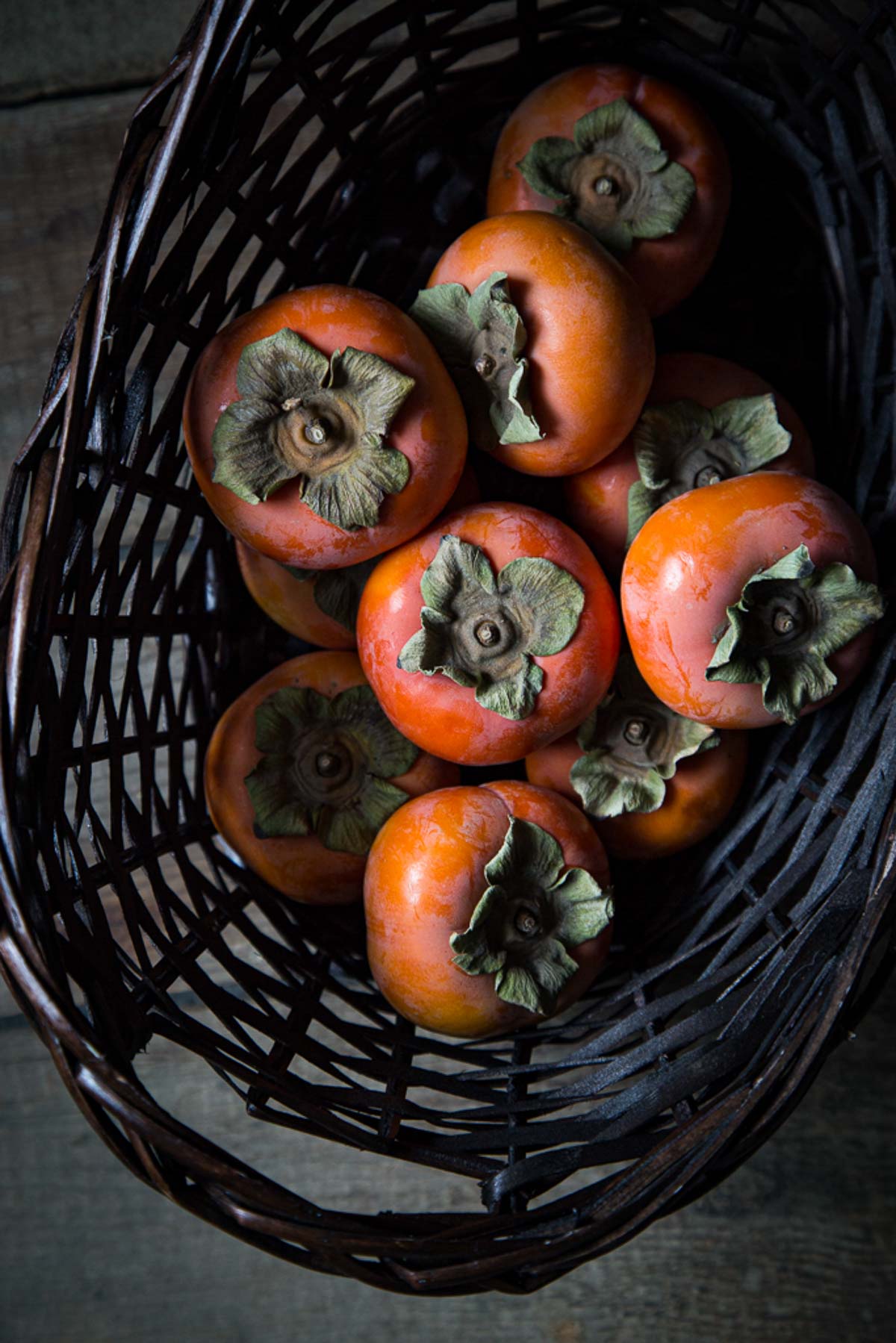 fuyu persimmons in basket fuyu persimmons in basket