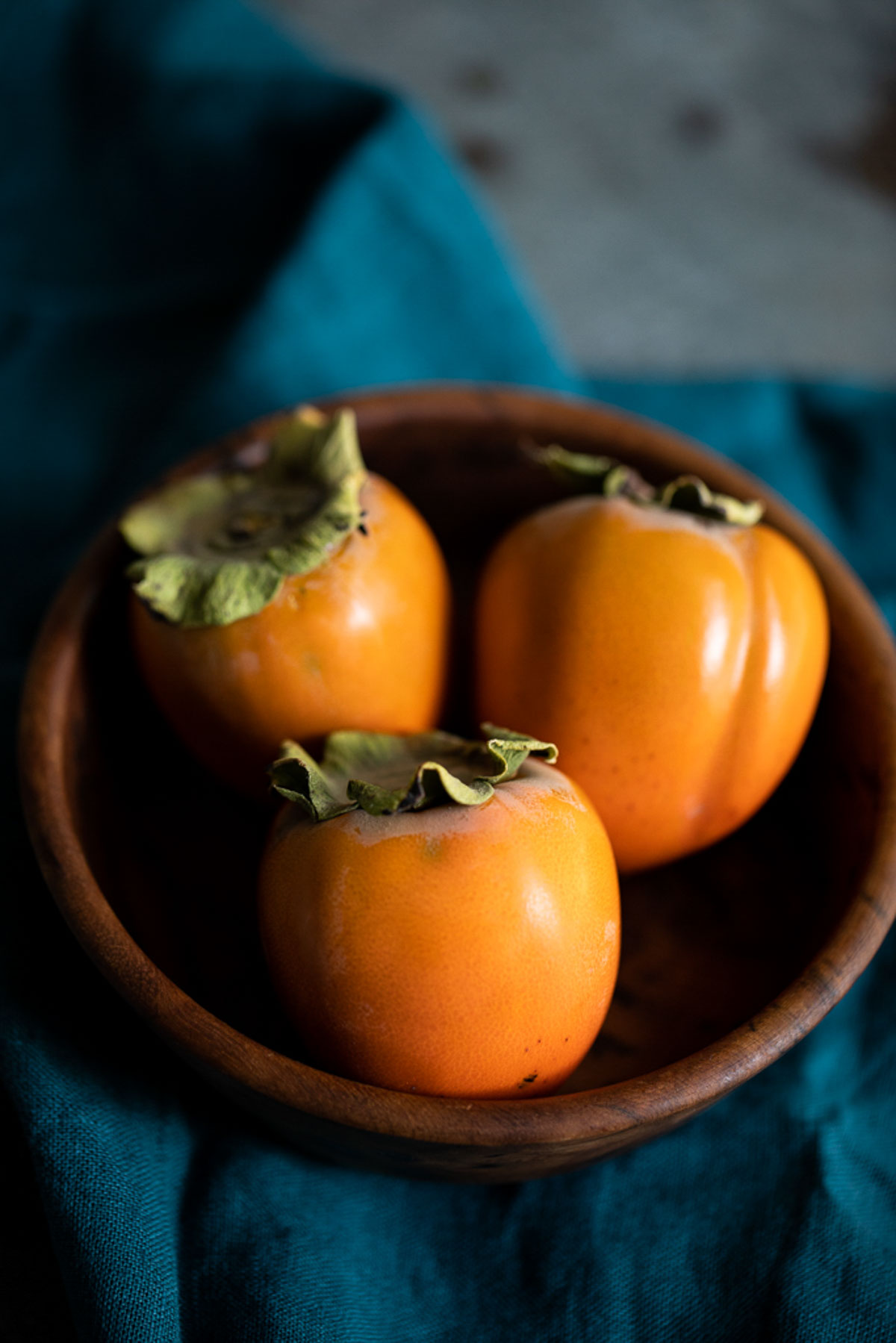 hachiya persimmon in wood bowl - - natural fall decor idea