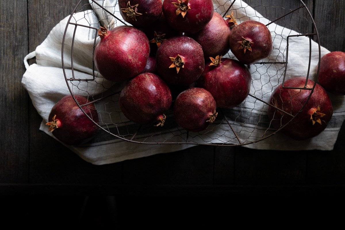 pomegranates in wire basket - - natural fall decor idea