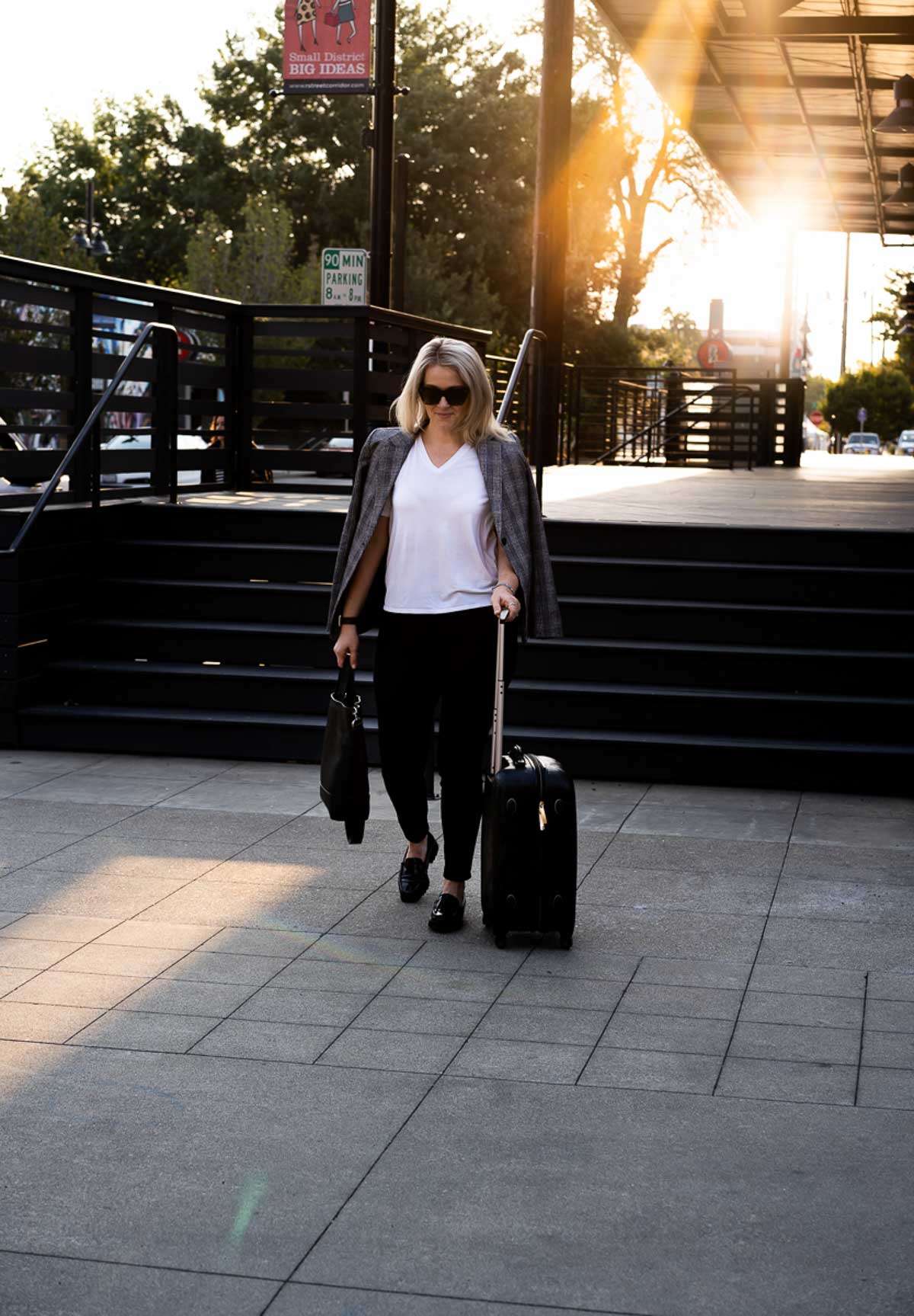 Fall Travel Outfits - White Tee + Jeans - Walking with Spinner Suitcase