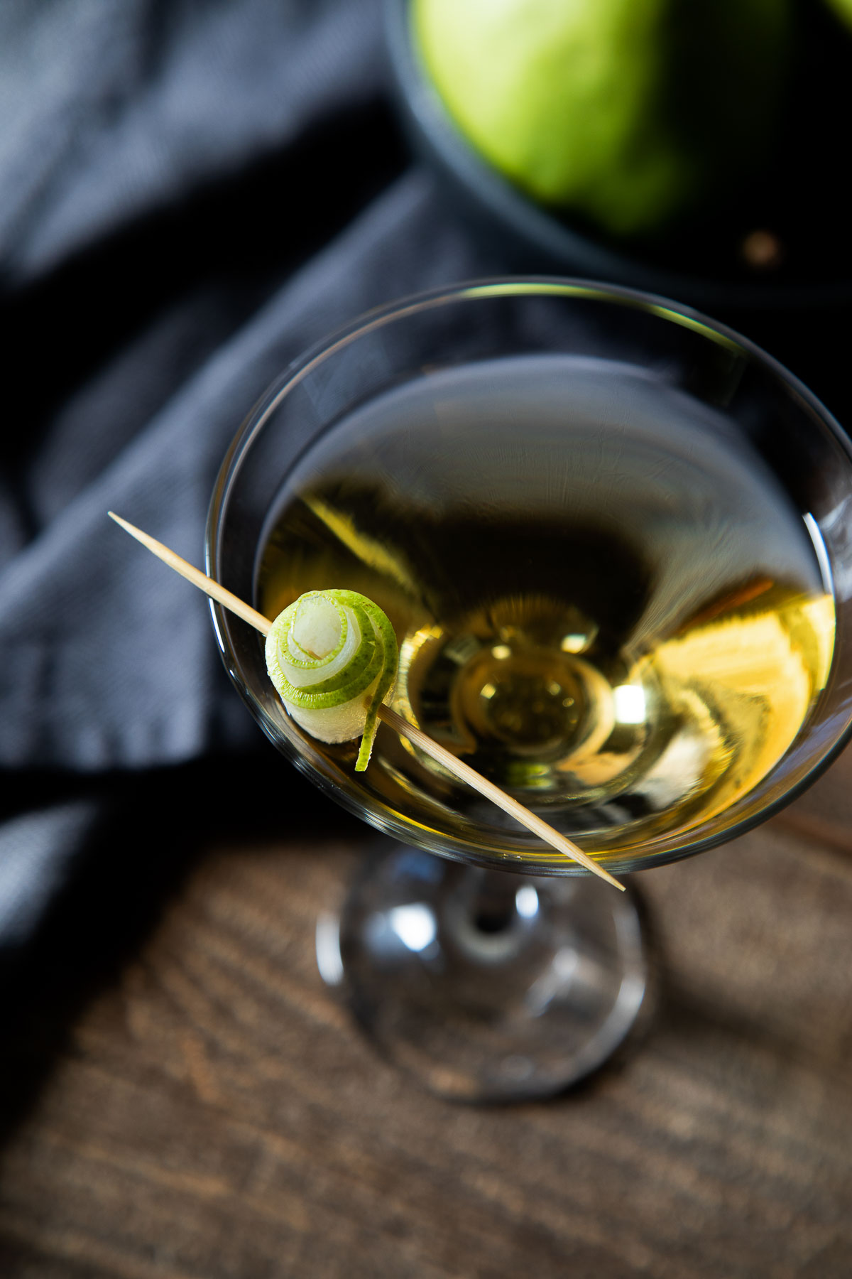 Pear Martini with curled pear slice on cocktail stick