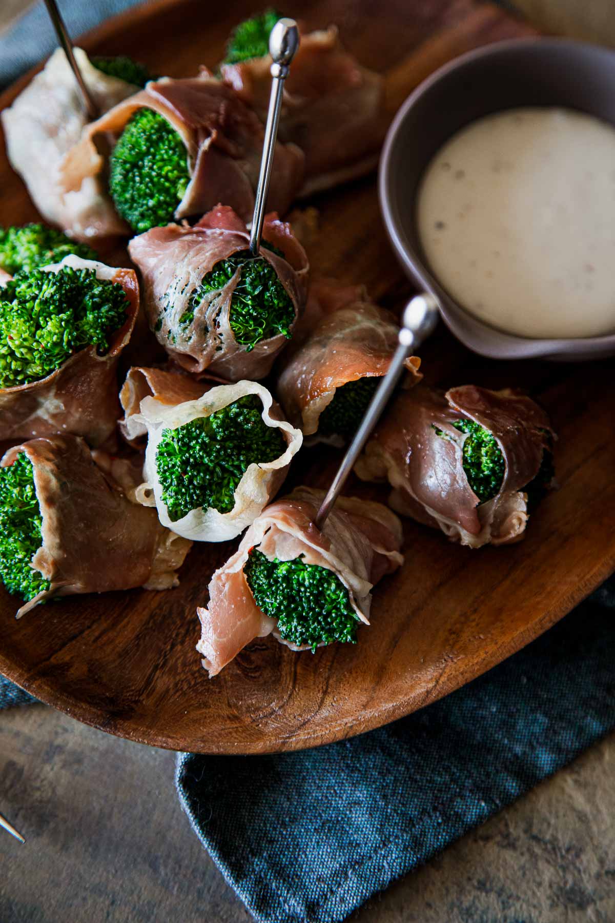 Prosciutto Wrapped Broccoli Appetizer on Wood Plate