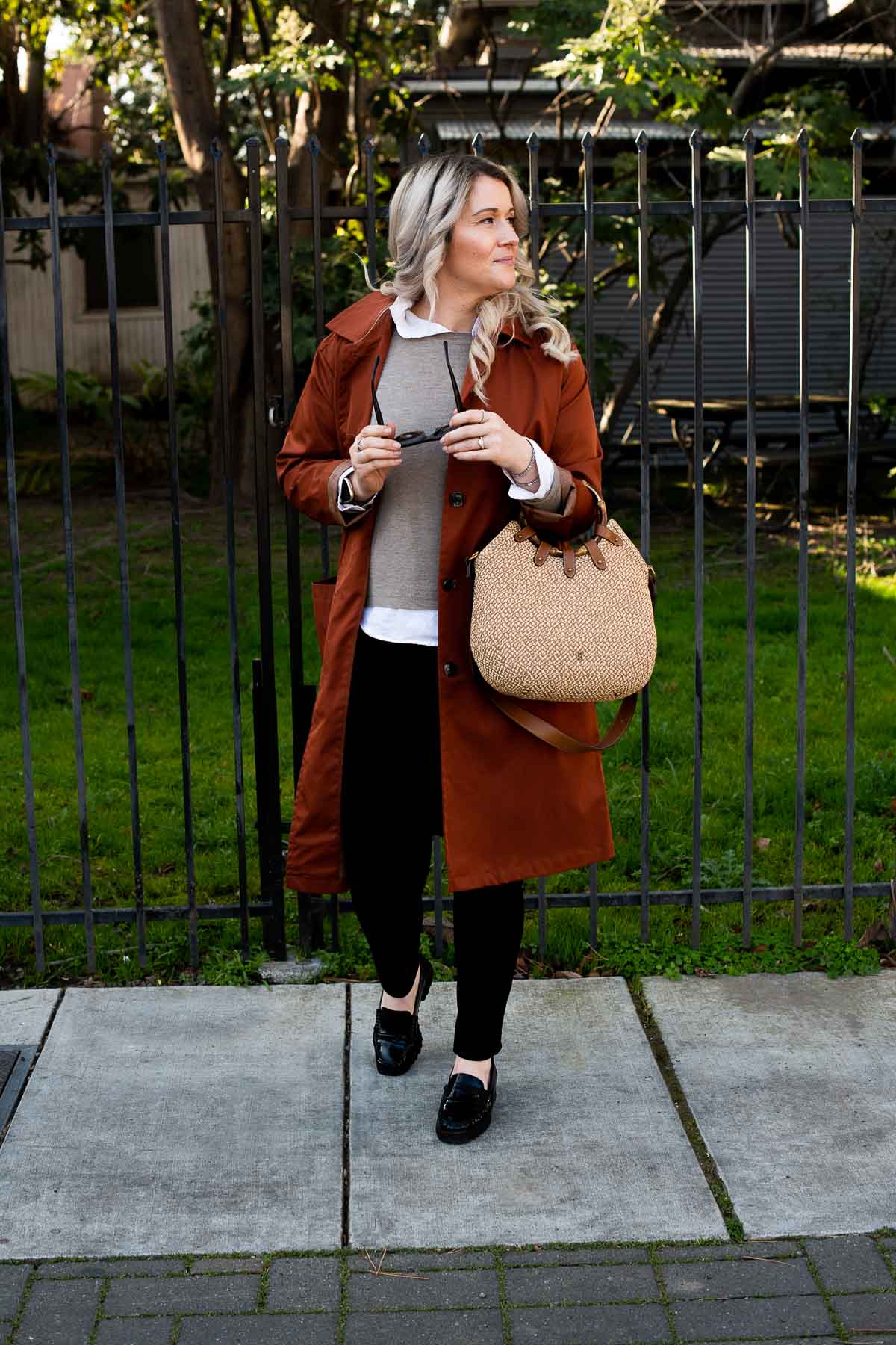 Luci in Linen in Winter Outfit, looking to left, holding sunglasses