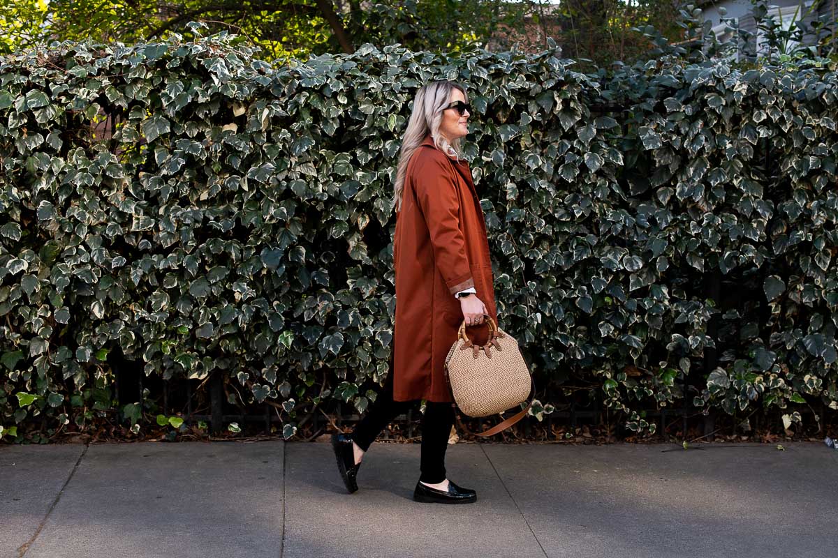 Luci Walking in Front of Leave in Burnt Orange Brown Coat