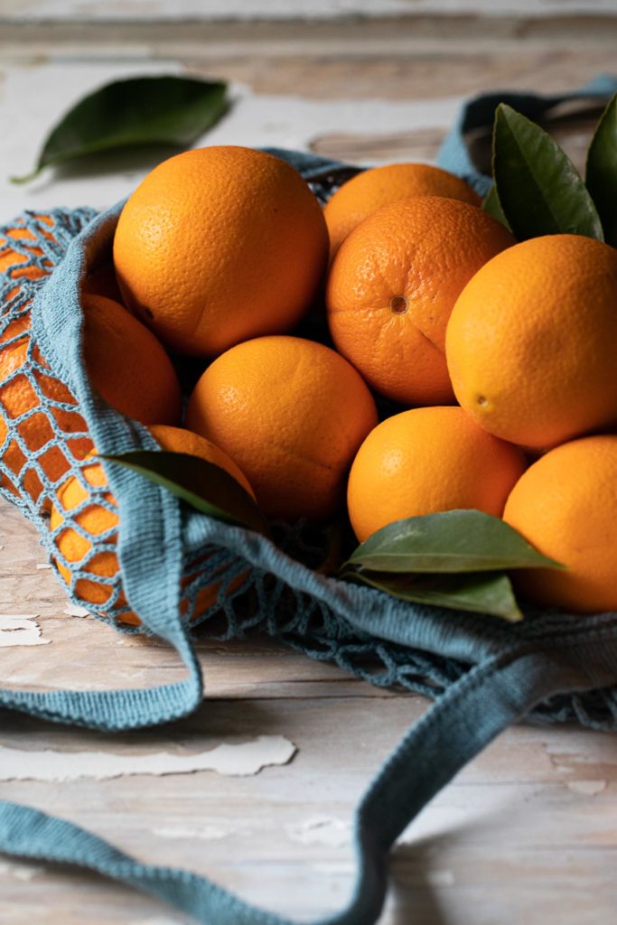 oranges in turquoise market bag - when to throw away food