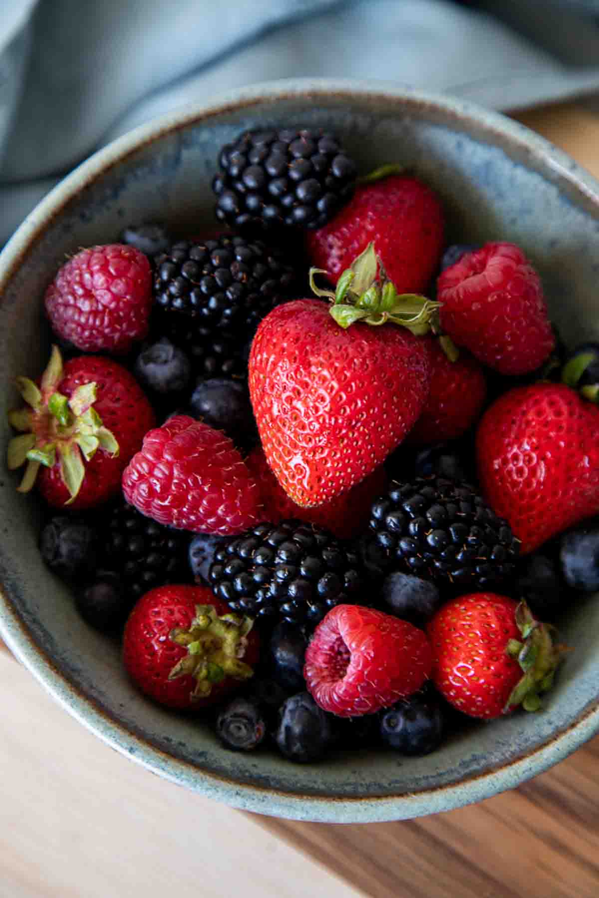 mixed berries in blue bowl