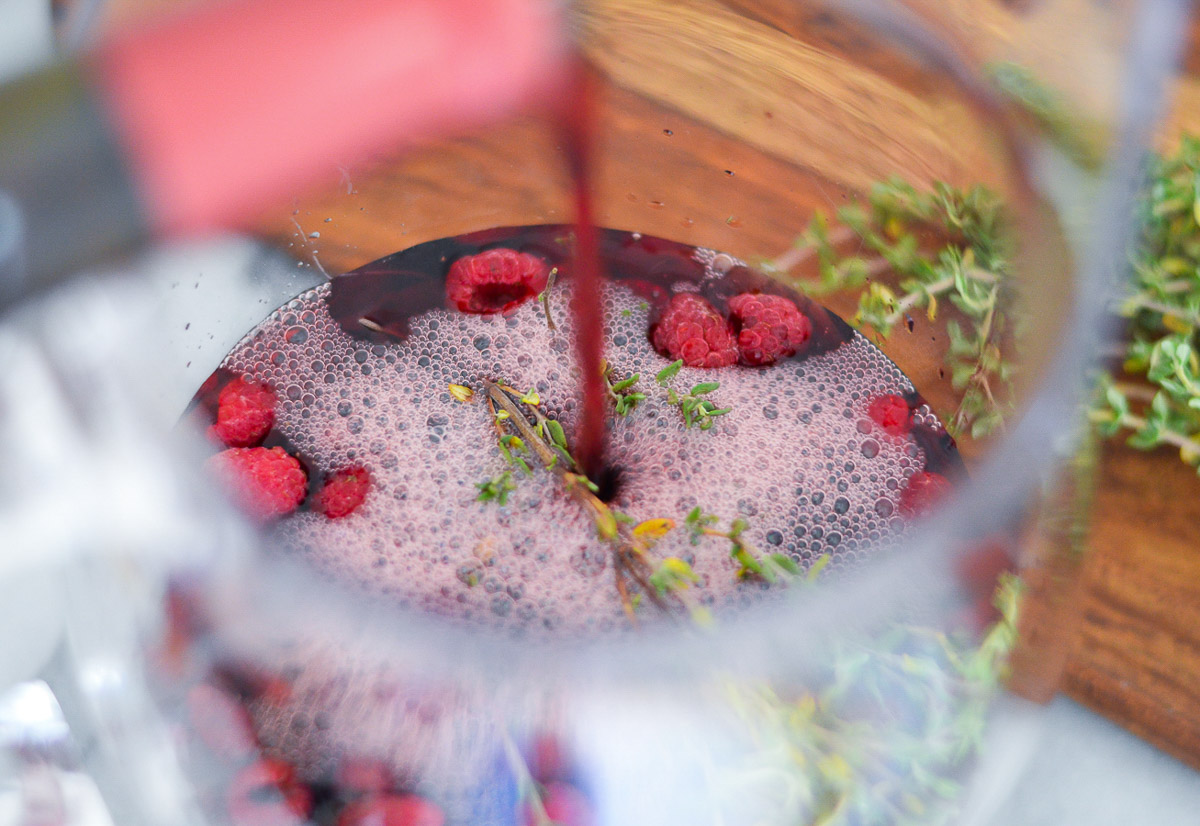 Pouring Wine into Pitcher of Raspberry Sangria