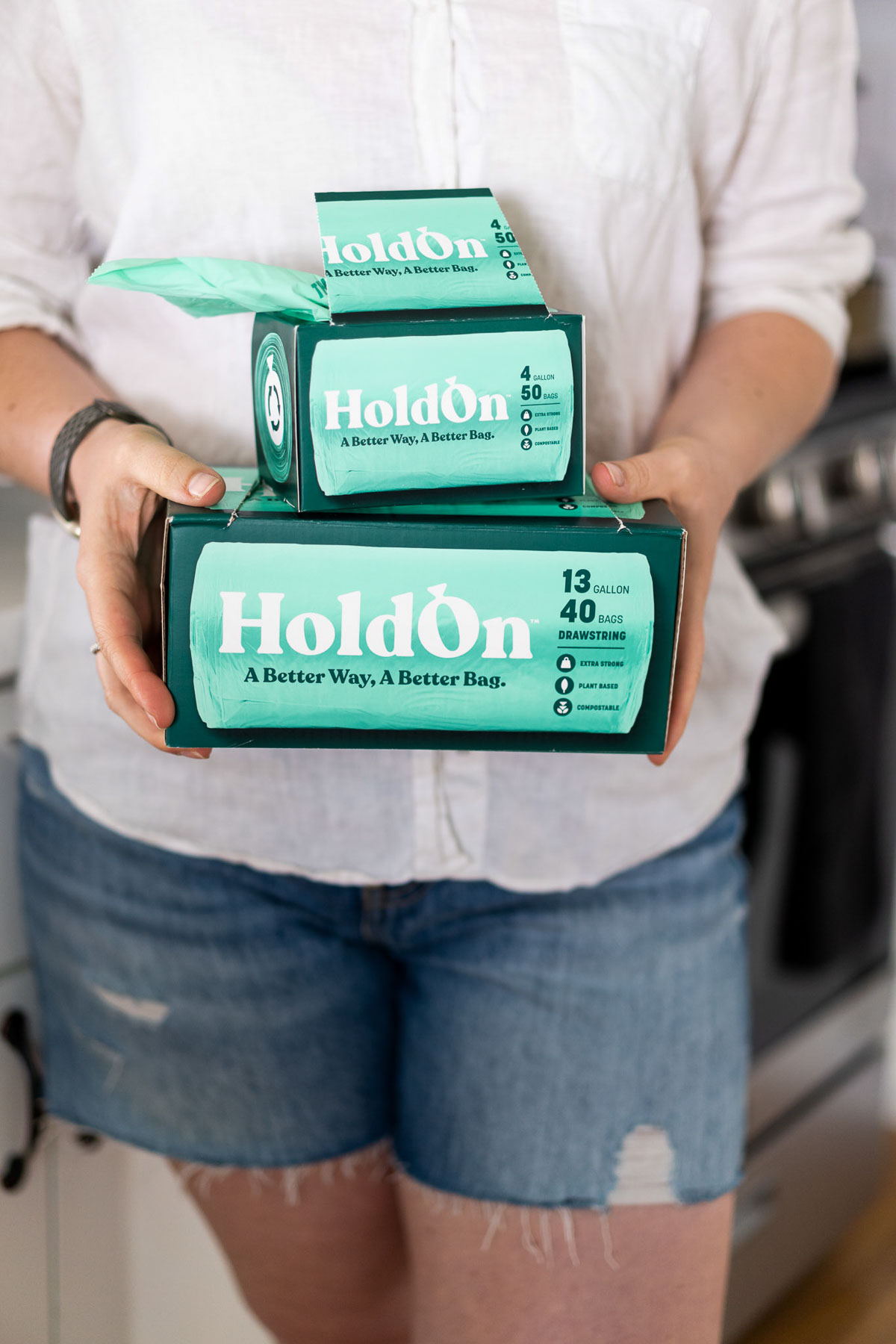 Luci holding boxes of HoldOn Compostable Bags