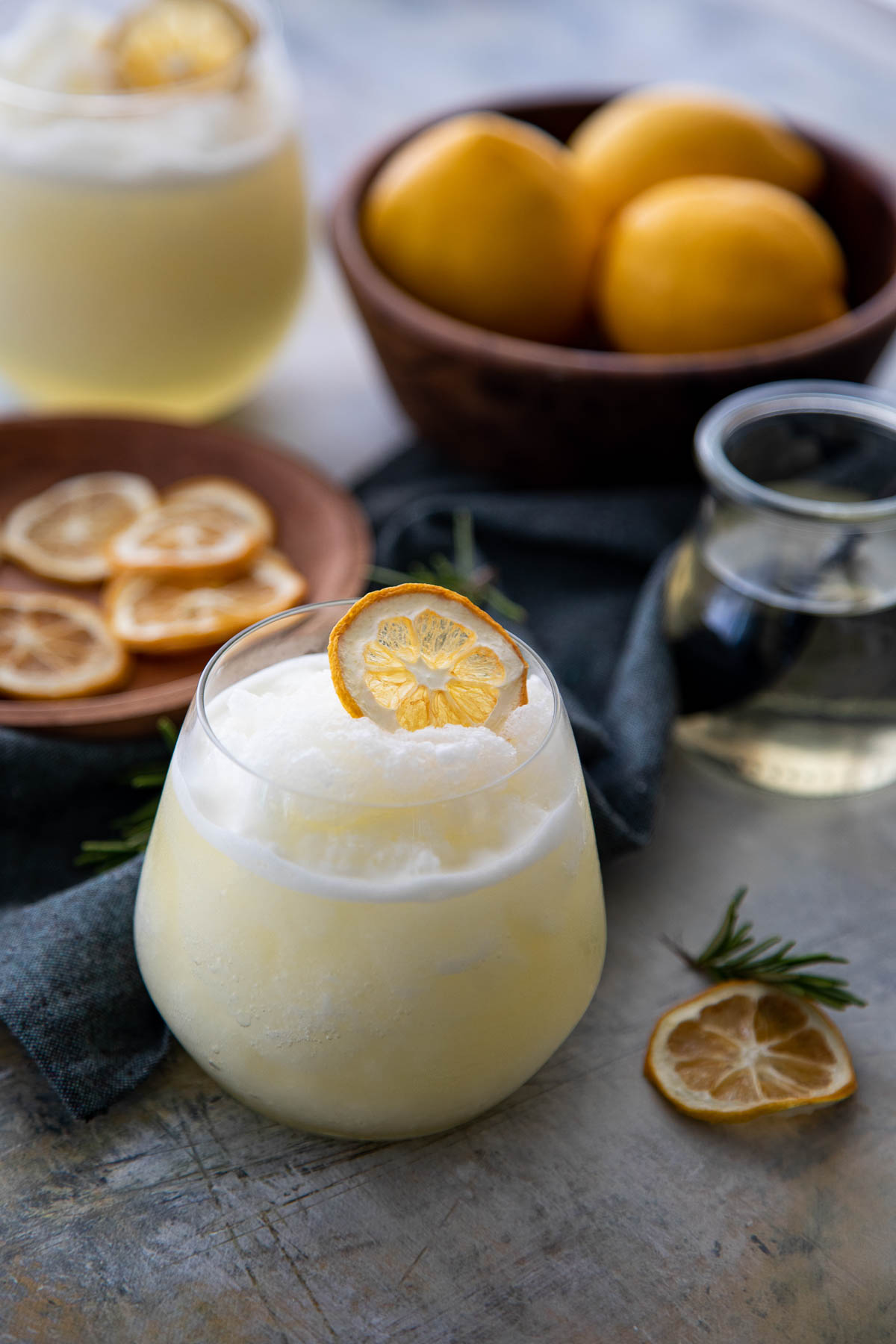 Rosemary Lemonade Slushy in Stemless Wine Glass with Dried Lemon Slice