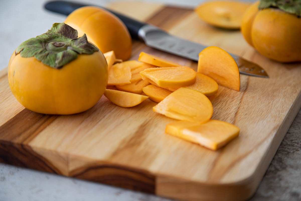 fuyu persimmon - sliced on cutting board