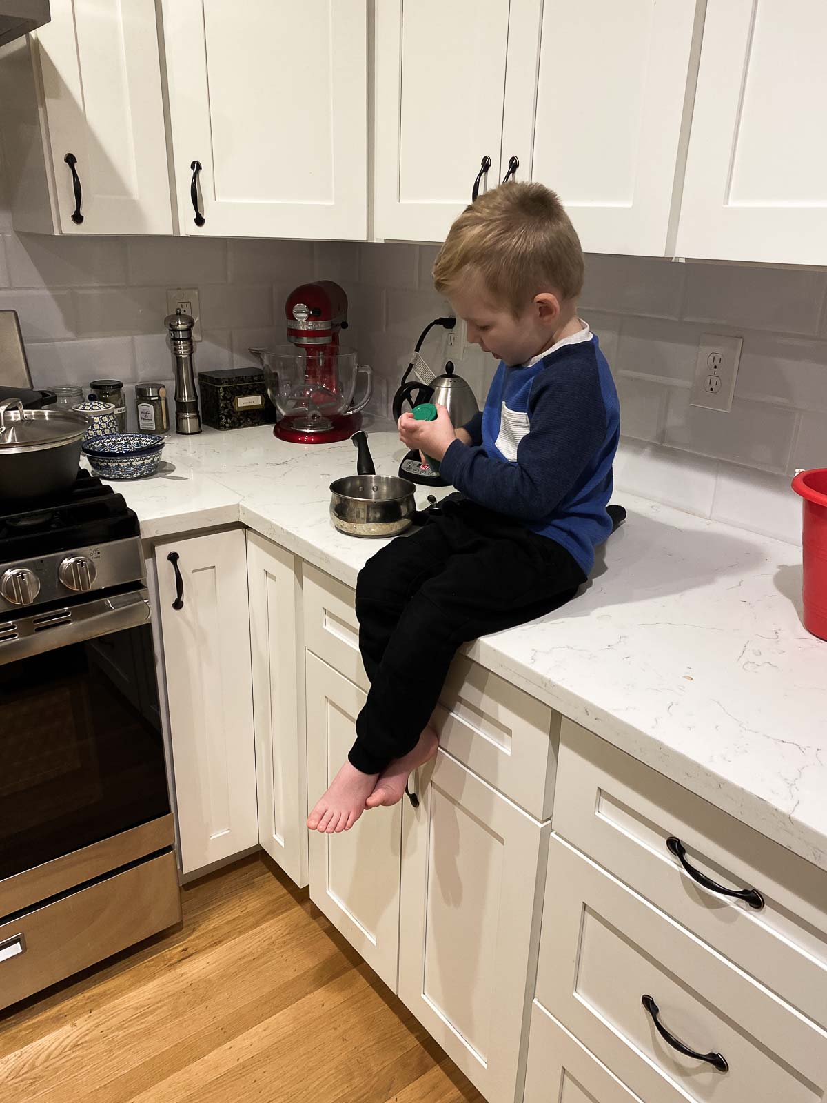 Kid sitting on counter - Toddlers and Food Waste