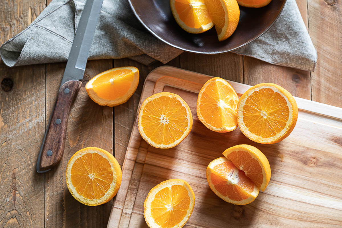 vitamin C for skin brightening products - Oranges cut open on cutting board