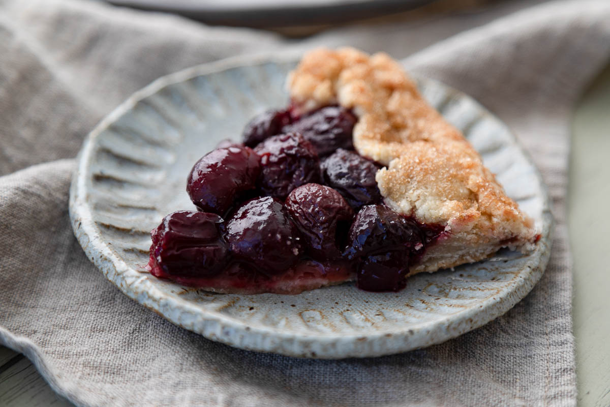piece of cherry galette on blue plate