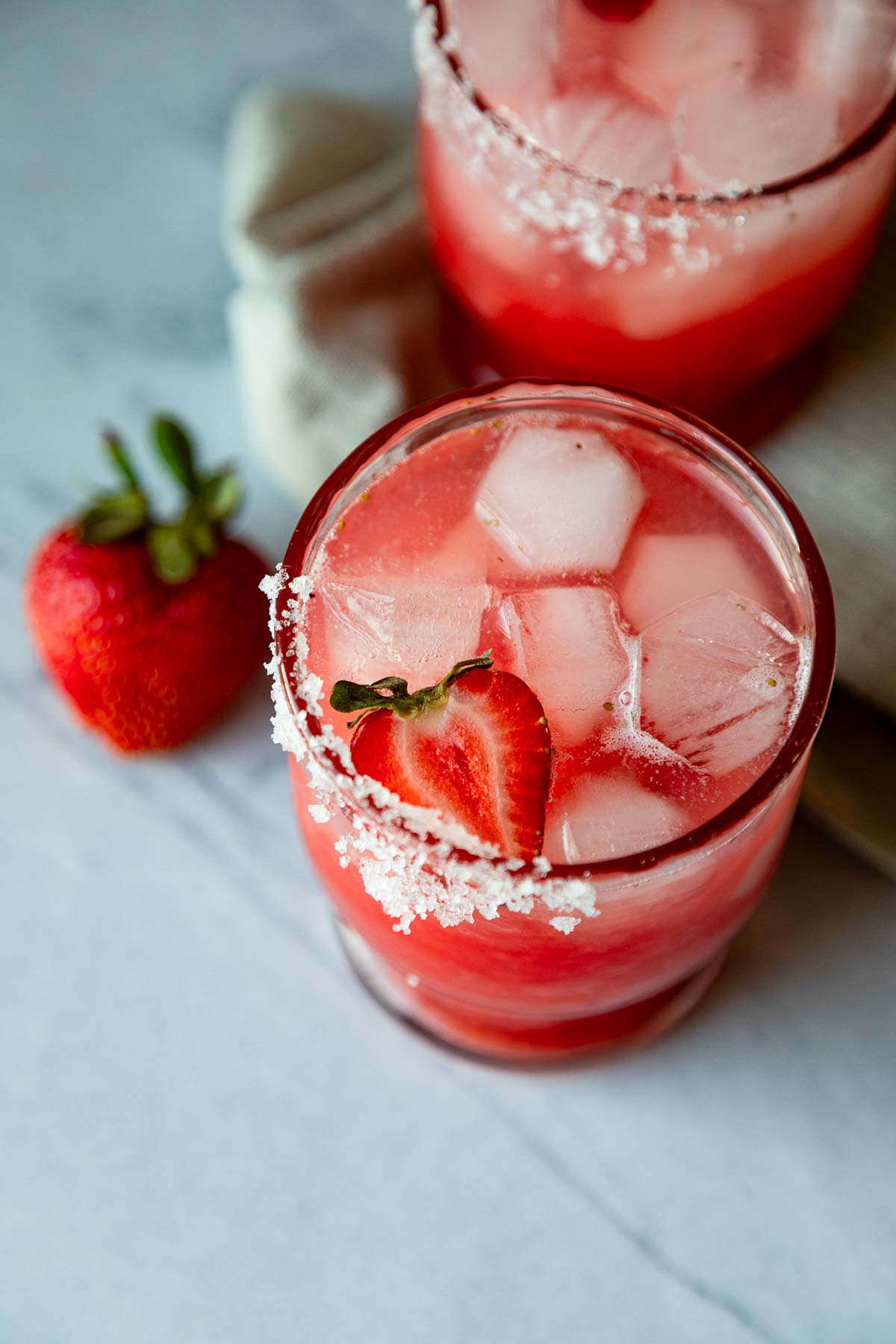 strawberry margarita on the rocks in 2 glasses