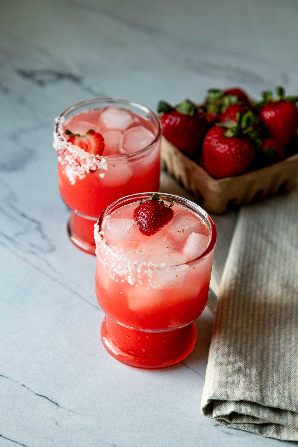 strawberry margarita on the rocks in 2 glasses