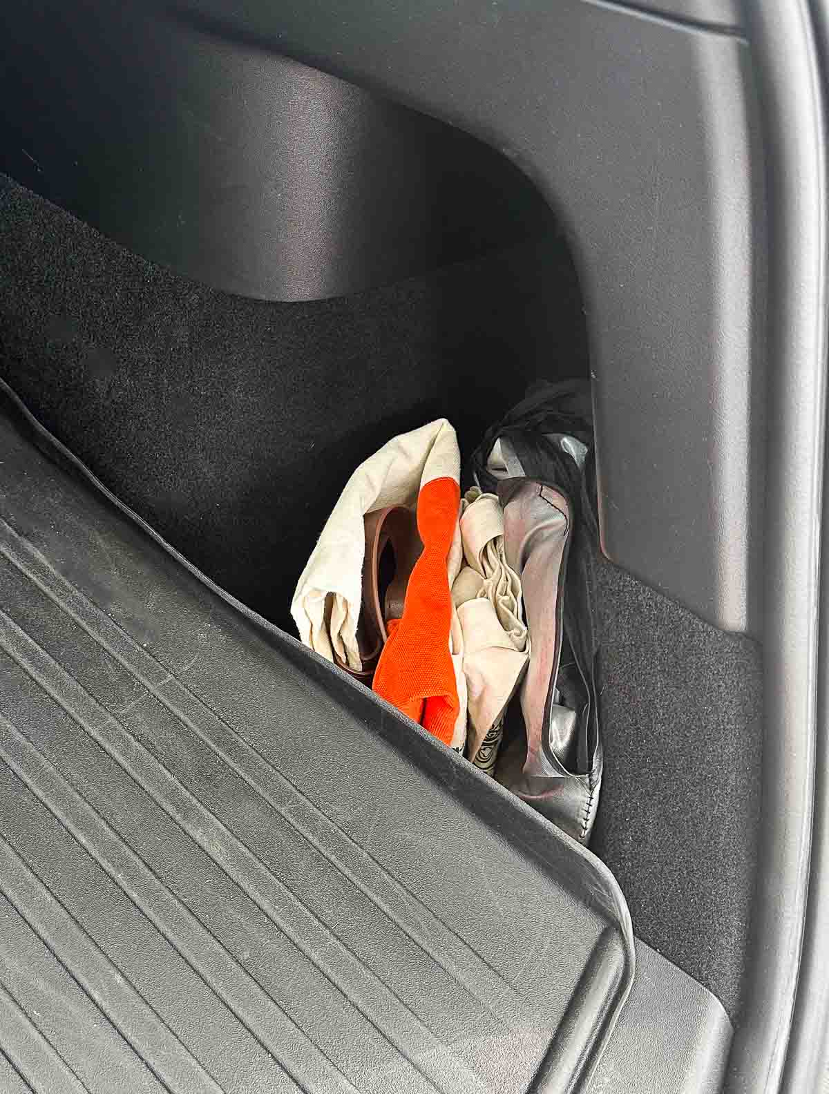 What to Keep In Your Car - clean trunk with reusable bags and sunshades organized in side