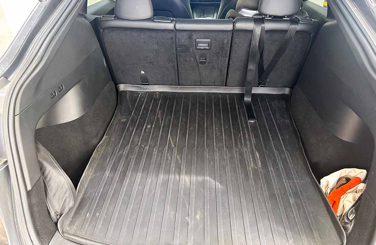 What to Keep In Your Car - clean trunk with reusable bags and sunshades organized in side