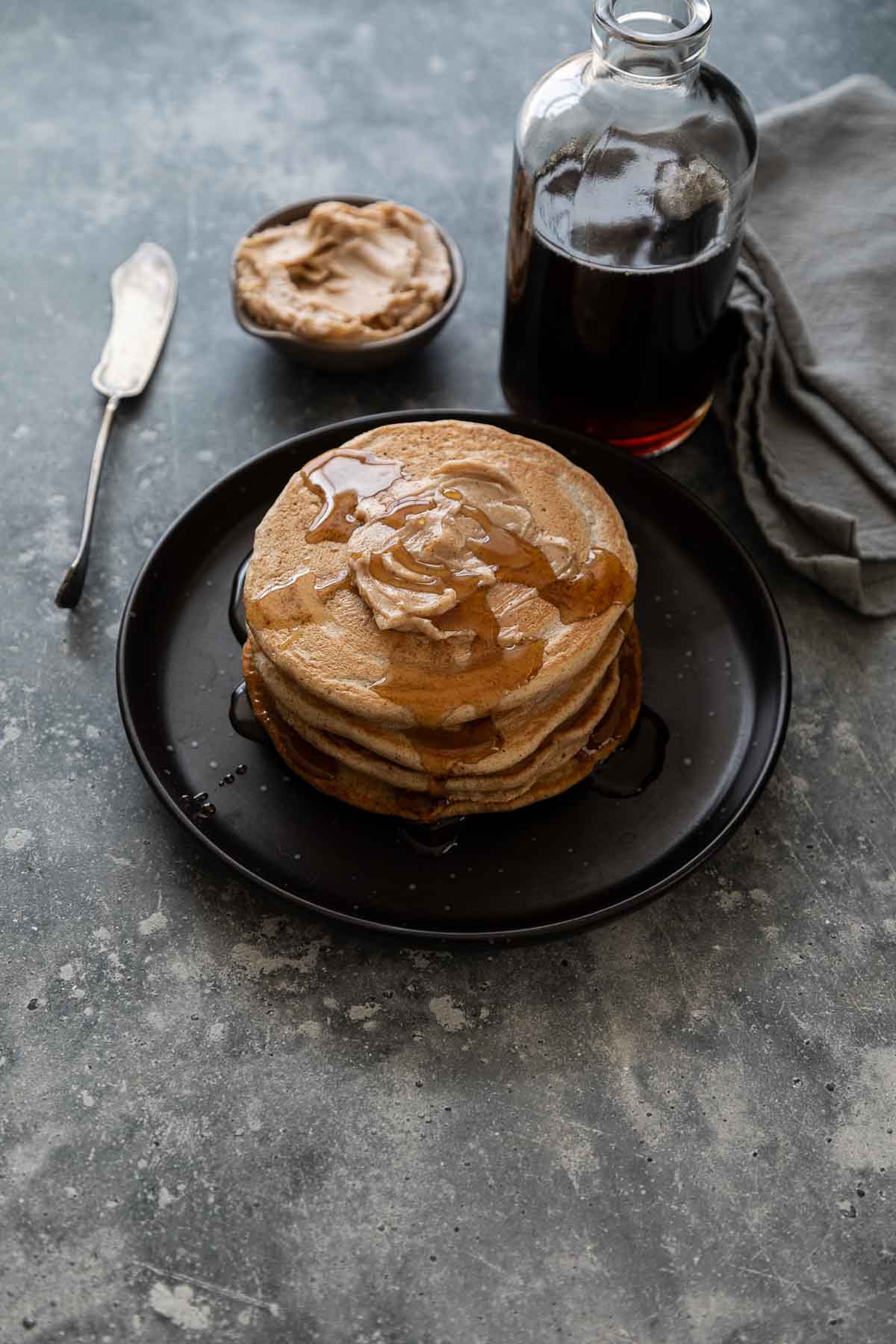 Cinnamon Pancakes with butter and syrup on top and to the side